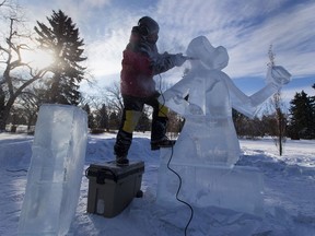 Carver Kelly Davies works on a ice sculpture of a moose playing a violin on Borden Park in preparation for the Deep Freeze Festival which starts this Friday. Taken on Wednesday, Feb. 3, 2021 in Edmonton.