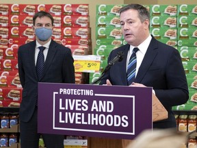Premier Jason Kenney and Minister of Labour and Immigration Jason Copping are seen at Belmont Sobeys in Edmonton on Wednesday, Feb. 10, 2021. More than 380,000 frontline workers in Alberta will receive one-time payments of $1,200 from the government for working during the COVID-19 pandemic, it was announced.