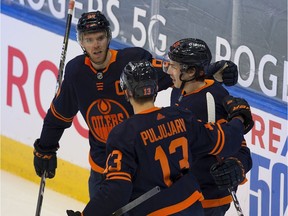 Edmonton Oilers Ryan Nugent-Hopkins (93) celebrates his goal against the Calgary Flames with teammates Connor McDavid (97) and Jesse Puljujarvi (13) during first period NHL action on Saturday, Feb. 20, 2021 in Edmonton.