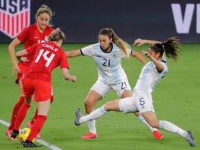 Canada's Gabrielle Carle (14), and Janine Beckie (16) battle against Argentina's Adriana Sachs (21), and Vanesa Santana (5) at the SheBelieves Cup at Exploria Stadium in Orlando, Fla., on Feb. 21, 2021.