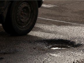 A pothole is seen along 137 Avenue west of 127 Street in Edmonton, on Tuesday, Feb. 23, 2021.