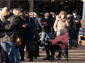 Hundreds of people with vaccination appointments queued outside of an Alberta Health Services clinic at Skyview Power Centre in Edmonton, on Thursday, Feb. 25, 2021.