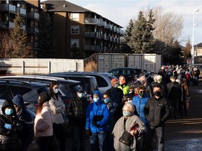 Hundreds of people with vaccination appointments queued outside of an Alberta Health Services clinic at Skyview Power Centre in Edmonton, on Thursday, Feb. 25, 2021. People said that they had waited two hours for a shot.