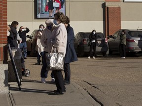 Seniors wait in long lines at the AHS COVID-19 vaccination clinic in the South Park Center in south Edmonton on Thursday, Feb. 25, 2021 .