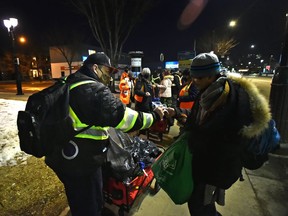 The Bear Clan Patrol are a group of volunteers help those struggling by bring food and drink along 118 Avenue in Edmonton, Wednesday, Feb. 24, 2021.