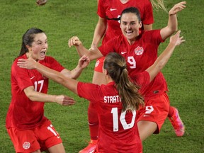 Canada midfielder Sarah Stratagakis (No. 10) celebrates with teammates Jessie Fleming (17) and Evelyne Viens (No. 9) after her game-winning goal against Argentina in their SheBelieves Cup international soccer tournament game at Exploria Stadium in Orlando, Florida on February 21, 2021.
