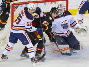 Calgary Flames Sean Monahan looks to redirect to the puck past goalie Mikko Koskinen of the Edmonton Oilers during NHL hockey in Calgary on Saturday February 6, 2021.