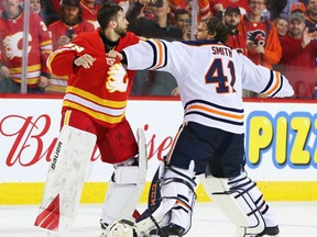 Calgary Flames goalie Cam Talbot and Edmonton Oilers goalie Mike Smith fight during NHL action in Calgary on Feb. 1, 2020.