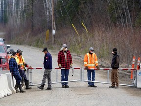 Residents, including Chief Wilfred King, far right, stand at a checkpoint restricting access to their community to slow the spread of coronavirus disease (COVID-19) in their remote First Nations community of Gull Bay, Ontario, Canada April 27, 2020.