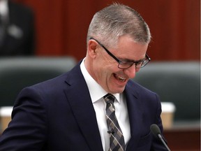 Finance Minister Travis Toews laughs as he prepares to deliver the 2021 budget at the Alberta legislature, Thursday, Feb. 25, 2021.