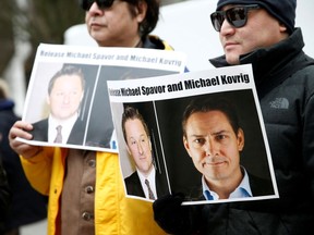 People hold signs calling for China to release Canadian detainees Michael Spavor and Michael Kovrig, in Vancouver, British Columbia, Canada, March 6, 2019. File photo.