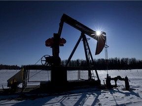 A pumpjack pumps oil from a well on a farmer's frozen field  in a Pembina oil field near Pigeon Lake, Alberta, Canada on Friday, Feb. 17, 2012.