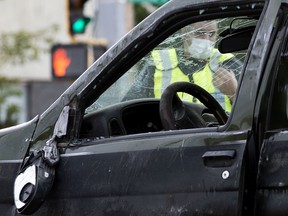 Police and emergency crews work at the scene of a serious vehicle collision in the 107 Avenue and 101 Street, in Edmonton Friday Aug. 14, 2020. File photo.