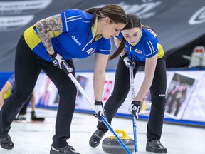 Team Alberta third Kate Cameron (L) and second Taylor McDonald sweep in draw twenty-two, the Scotties Tournament of Hearts 2021, the Canadian Women's Curling Championship. Special to Postmedia /Andrew Klaver /POOL