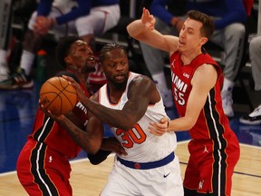 Duncan Robinson and Bam Adebayo of the Miami Heat defend against Julius Randle of the host New York Knicks at Madison Square Garden on Feb. 7, 2021.