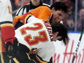 The Edmonton Oilers' Ryan Nugent-Hopkins (93) fights the Calgary Flames' Sean Monahan (23) during first period NHL action at Rogers Place, in Edmonton Wednesday Jan. 29, 2020.