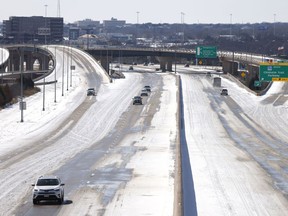 Traffic moves along Interstate 30 after a snow storm February 15, 2021 in Fort Worth, Texas. Winter storm Uri has brought historic cold weather to Texas and storms have swept across 26 states with a mix of freezing temperatures and precipitation.