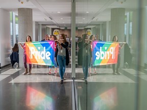 Students cross the medway at a previous Pride march through MacEwan University.