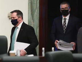 Premier Jason Kenney and Minister of Finance Travis Toews arrive to deliver the 2021 Alberta Provincial budget at the Alberta Legislature, in Edmonton Thursday Feb. 25, 2021.