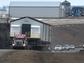 Crews moving large commercial building headed west on Highway 19 near Devon in Edmonton, Wednesday, February 22, 2017.
