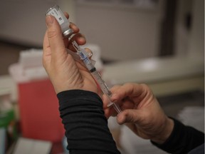 A shot of vaccine is prepared at Clifton Manor in Calgary on Jan. 26, 2021.