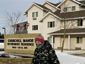 A woman walks by the Churchill Manor Retirement Residence in southeast Edmonton on Wednesday, March 3, 2021, where a COVID-19 variant outbreak was declared by the Alberta government. The facility reported 27 cases of coronavirus with 19 cases confirmed as variant cases to date.