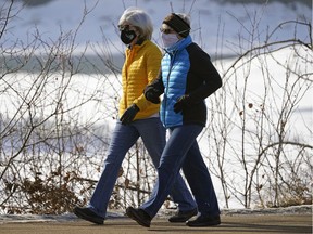 Two women take a brisk stroll on River Valley Road in Edmonton on Thursday March 4, 2021.