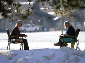 Two women enjoy the afternoon sunshine at Hawrelak Park in Edmonton on Friday March 5, 2021 as temperatures reached a high of 8 C degrees.