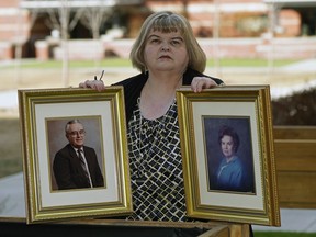 Lynda Stewart holds a photo of her father Lowell Stewart and her mother Jean Stewart outside her home in Sherwood Park, on Friday, March 19, 2021. Both of her parents died from COVID-19. Lynda also contracted the coronavirus and almost died but has since recovered.