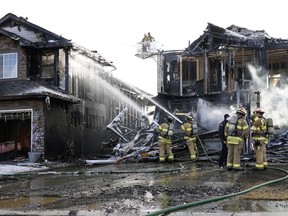 Firefighters battle a residential house fire that started near 137 Avenue and 37 Street in Edmonton on Tuesday morning, March 23, 2021.