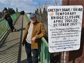 Terrace Heights resident Charlie Richmond next to a sign posted by the city, saying its closing the 104 Avenue pedestrian bridge over Wayne Gretzky Drive. Initially scheduled to be closed from April to October, the city has since created an alternative schedule for construction to take place only in the summer.