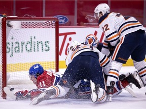 Montreal Canadiens right wing Brendan Gallagher (11) crashes into the net after diving across Edmonton Oilers goaltender Mikko Koskinen (19) to score the Canadiens third goal during NHL action in Montreal on Tuesday, March 30, 2021.