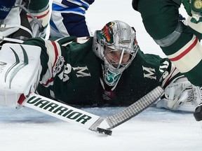 ST PAUL, MN - OCTOBER 31: Alex Stalock #32 of the Minnesota Wild makes a stick save as Joel Armia #40 of the Winnipeg Jets falls onto him during the first period of the game on October 31, 2017 at Xcel Energy Center in St Paul, Minnesota.