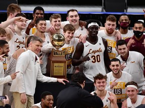 Aher Uguak (30) and the Loyola University of Chicago Ramblers pose for a team photo after defeating the Drake University Bulldogs in the finals of the Missouri Valley Conference Tournament at Enterprise Center in St. Louis on Mar 7, 2021.