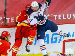 Calgary Flames' Noah Hanifin collides with Connor McDavid of the Edmonton Oilers