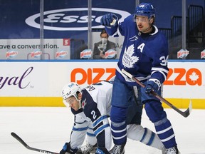 Jets defenceman Dylan DeMelo tries to defend against Leafs sniper Auston Matthews. GETT IMAGES