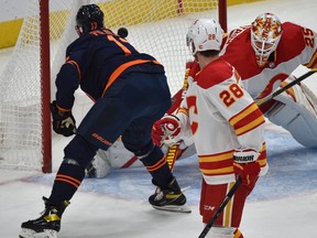 Edmonton Oilers Jesse Puljujarvi (13) scores on Calgary Flames goalie Jacob Markstrom (25) during NHL action at Rogers Place in Edmonton, March 6, 2021.
