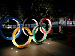 FILE PHOTO: The Olympic rings are illuminated in front of the National Stadium in Tokyo, Japan January 22, 2021. REUTERS/Kim Kyung-Hoon//File Photo ORG XMIT: FW1