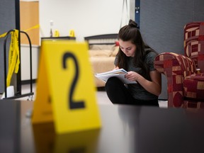 A student takes notes in MacEwan University’s crime lab within the Police and Investigations program. The crime lab engages students in simulated investigation activities based on real-life cases, so they can learn how to respond to changing circumstances and how to process a crime scene for evidence. (Photo was taken before COVID-19.)