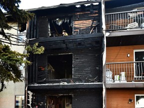 Fire investigators on the scene of an overnight low rise apartment fire where some residents had to be rescued by fire crews at 12014 82 Street in Edmonton, March 19, 2021.