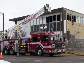 Firefighters battle a fire at a commercial building on 109 Street at 107 Avenue in downtown Edmonton on Wednesday morning, March 24, 2021. The cause of the fire is under investigation.