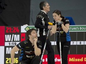 Calgary Ab,March 23, 2021.WinSport Arena at Calgary Olympic Park.Home Hardware Canadian Mixed Double Curling Championship.Kirk Muyres (L), and Laura Walker, (back center) Nancy Martin, during draw 28.Curling Canada/ Michael Burns Photo