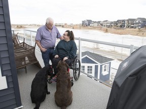 Rick and Sandra Statt, with their dogs, Shiloh, left, and Shelby, enjoy the view from the deck of their new bungalow with a walkout basement in the new community of Aspen Trails in Sherwood Park.