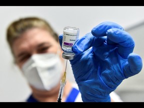 A health-care worker prepares a dose of the AstraZeneca coronavirus vaccine, as vaccinations resume after a brief pause in their use over concerns of a possible connection to blood clots, in Turin, Italy, on March 19.