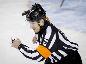 NHL referee Tim Peel works a game in Calgary in 2014.