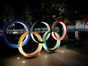 FILE PHOTO: The Olympic rings are illuminated in front of the National Stadium in Tokyo, Japan January 22, 2021. REUTERS/Kim Kyung-Hoon//File Photo ORG XMIT: FW1