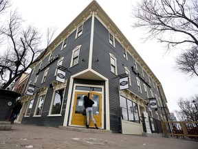 A customer peeks in the front door of Leopold's Tavern as the bar officially opens for business in the renovated Strathcona Hotel, now dubbed The Strathcona, in Edmonton Monday March 29, 2021.