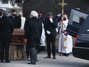 Wayne Gretzky sheds a few tears as the casket containing his father Walter is loaded into the back of a hearse after his funeral at St. Mark's Anglican Church in Brantford on Saturday March 6, 2021.