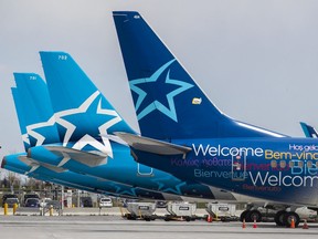 Idle Air Transat jets sit parked at Montréal-Pierre Elliott International Airport in Montreal Thursday May 7, 2020.