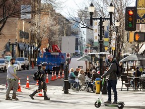 Pedestrians make their way past patios along 104 Street, in Edmonton on Friday April 16, 2021. 104 Street between Jasper Avenue and 102 Avenue will be closed to vehicles Saturday and Sundays for increased pedestrian access.